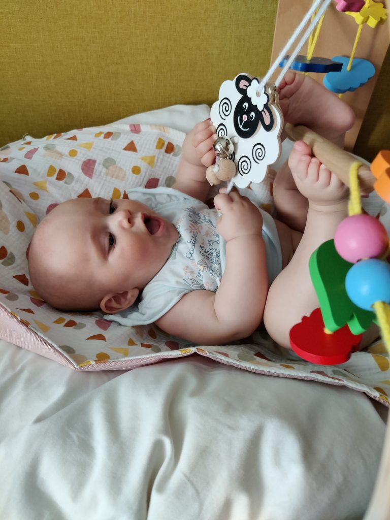 a toddler playing on a blanket